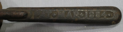 The embossed handle of a H F Osborne screw meat juice press