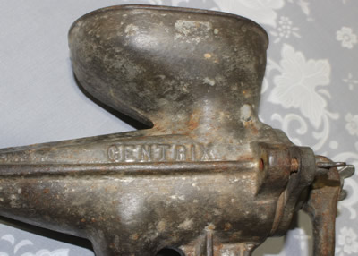 The embossed brand on a Centrix iron crank handle juicer