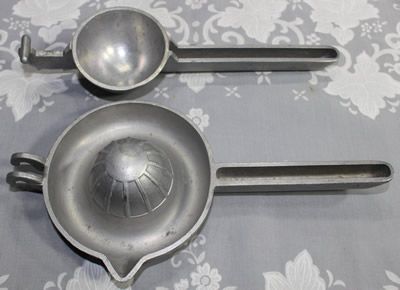 The two parts of a Trojan aluminium hand squeeze juicer