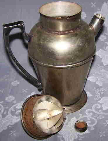 3 parts of a Taber & Tibbits silver plate cocktail shaker with juicer
