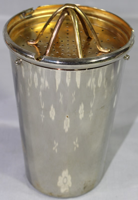 A DRGM GERMANY stainless steel cocktail shaker showing the juicer