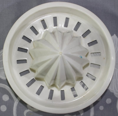 Juicer insert for a white top on red jug plastic juicer
