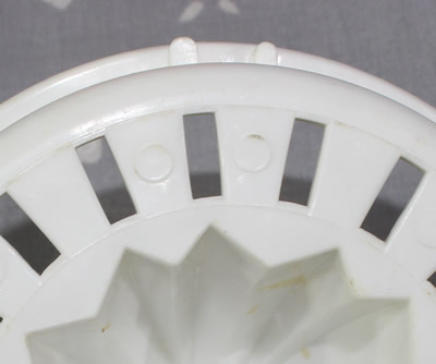 Notches on the juicer insert for a white top on red jug plastic juicer 