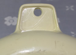 Tab hande shape for a beige plastic saucer juicer