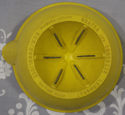 Bottom of mustard yellow BCM Monolines bakelite juicer showing zester