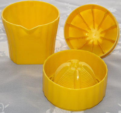 3 pieces of a yellow plastic squeezer juicer