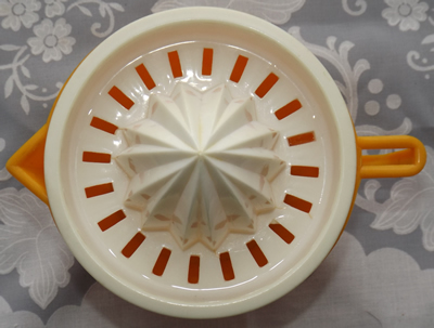 Light orange and white plastic 2 piece juicer