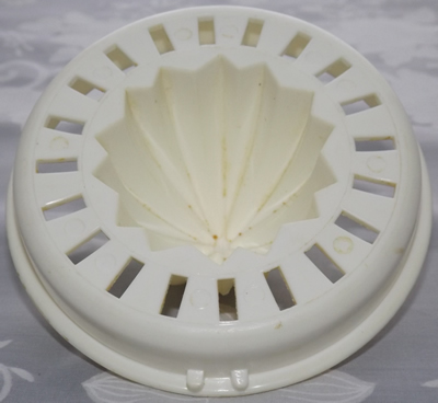 2 notches under white plastic juicer