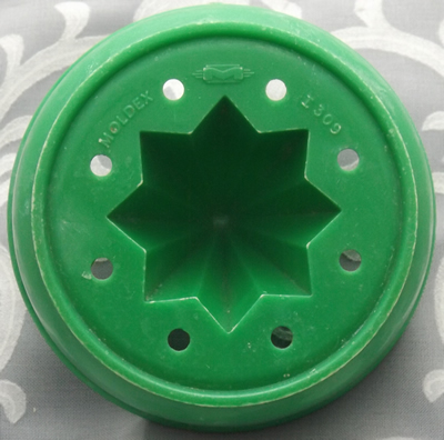 The bottom of the hard green plastic Moldex Australia juicer top 
