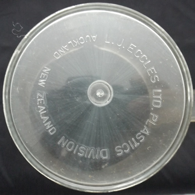 Embossed base on an olive green juicer on clear plastic jug