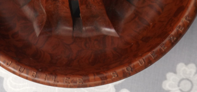 Red bakelite Jubilee Squeezer juicer showing embossed name