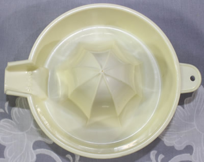 Top view of a cream BIPA plastic 1 piece juicer