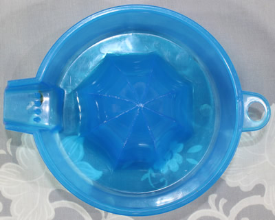 Top view of a transparent blue BIPA plastic 1 piece juicer