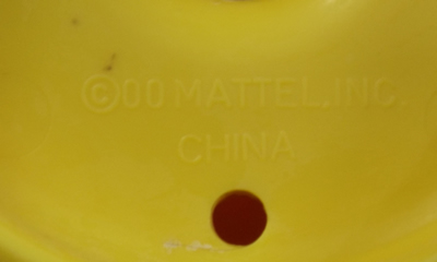 Embossed label on Red reamer on yellow jug toy juicer
