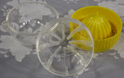 3 parts of Yellow and clear plastic squeezer juicer