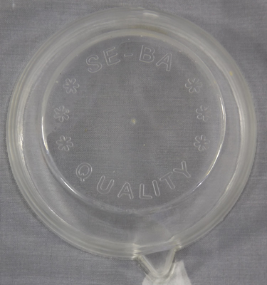 The base of a yellow and clear plastic squeezer juicer