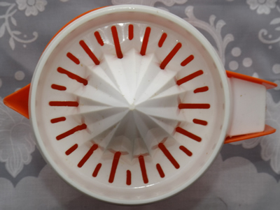 Top view of a red and white HOSTESS plastic juicer