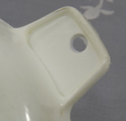 Tab hande shape for a white plastic saucer juicer
