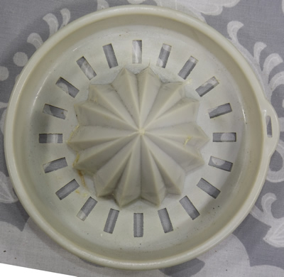 Cream plastic jug with grey reamer