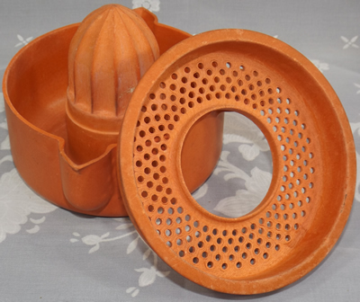 2 parts of a Orange Dodca Bakelite juicer