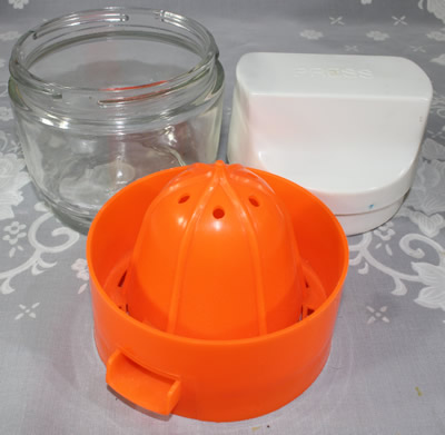 3 parts of a Gemco orange plastic juicer