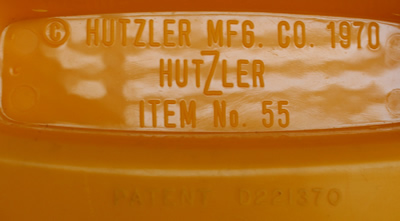 Embossed details on the base of a light orange Hutzler plastic juicer 