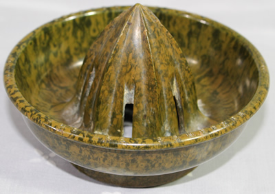 Reamer for a mottled Bakelite Jubilee juicer on a panelled glass jar