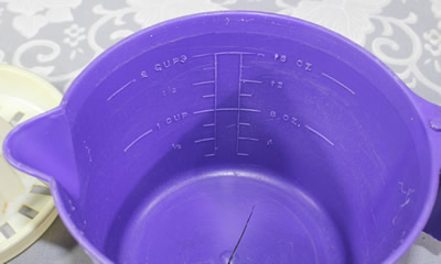 Inside measurements on a purple and white plastic notched jug juicer
