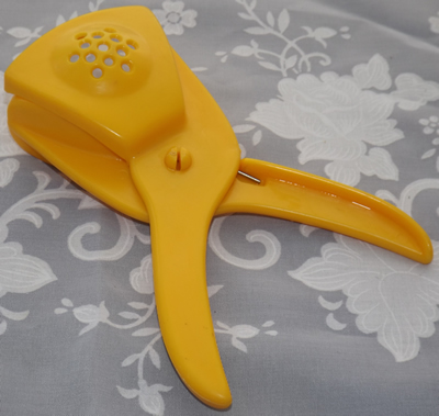 Yellow plastic wedge squeezer juicer bottom view