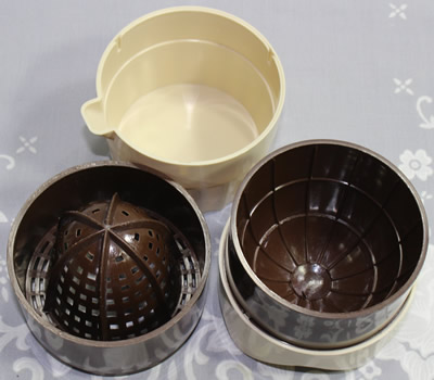 The 3 parts of a W. Germany buff and brown plastic squeezer juicer