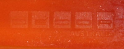 The Decor logo on an orange and yellow plastic pot shape juicer