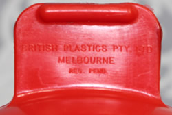 The branding on a dark red British Plastics Pty. Ltd. saucer juicer
