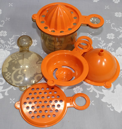 The parts of a Kitchen Mate 5 in 1 orange juicer closed