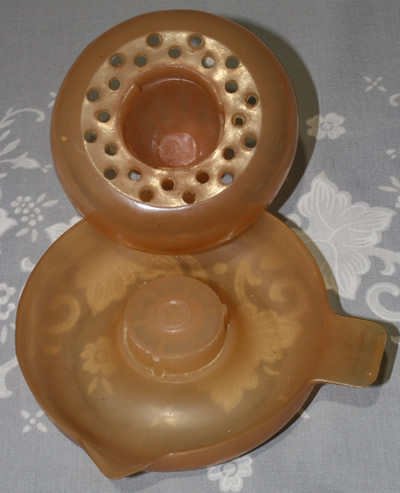 The 2 parts of an Australian Duperite Everware translucent orange plastic 2 piece juicer