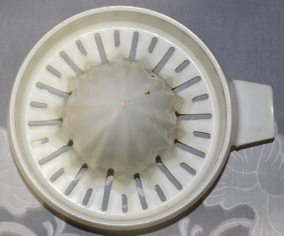The juicer insert for a dark red and white HOSTESS plastic juicer