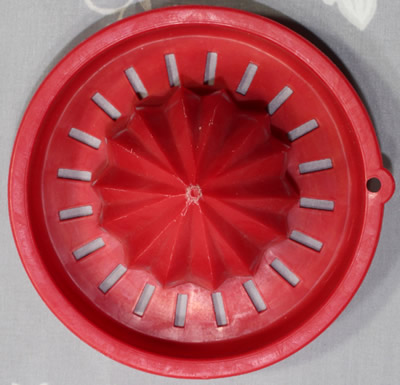 The top view of a crimson red reamer for Tupperware bowl