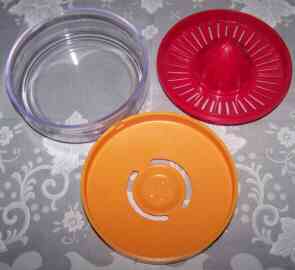 3 piece Clear, orange & red plastic juicer - top view