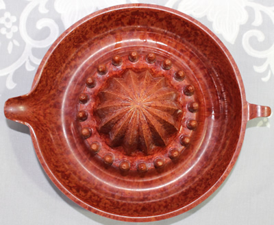 Top view of a mottled red bakelite juicer