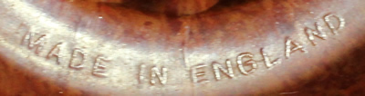 Embossed mark on a mottled red bakelite juicer