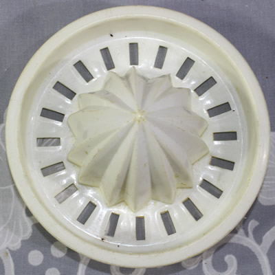 The reamer for an olive green plastic jug with white juicer