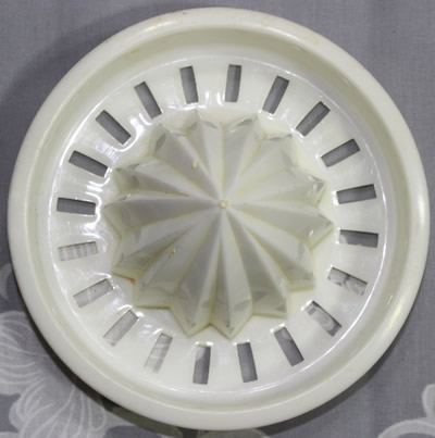 The reamer for a yellow plastic jug with white top juicer
