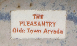 The Pleasantry label on a blue & grey pottery loop handle juicer