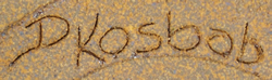 Potter's signature on Dark brown hand thrown pottery juicer