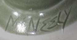 Potter's signature on Pale green hand thrown pottery juicer with strap handle