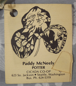 Label on Pale green hand thrown pottery juicer with strap handle