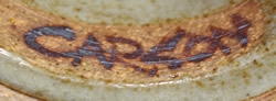 Potters mark on Carson hand thrown brown on grey coloured pottery juicer