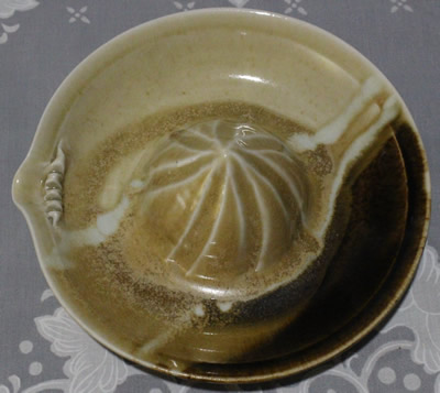 Top view of a cream through to brown pottery juicer