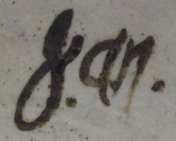 Potter's signature on a cream through to brown pottery juicer