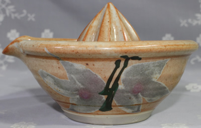 Side view of Fergus Stewart's tan & grey mushroom cone pottery juicer