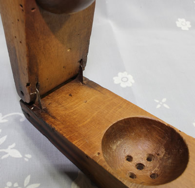 The base and hinge of a wood hand squeezer juicer